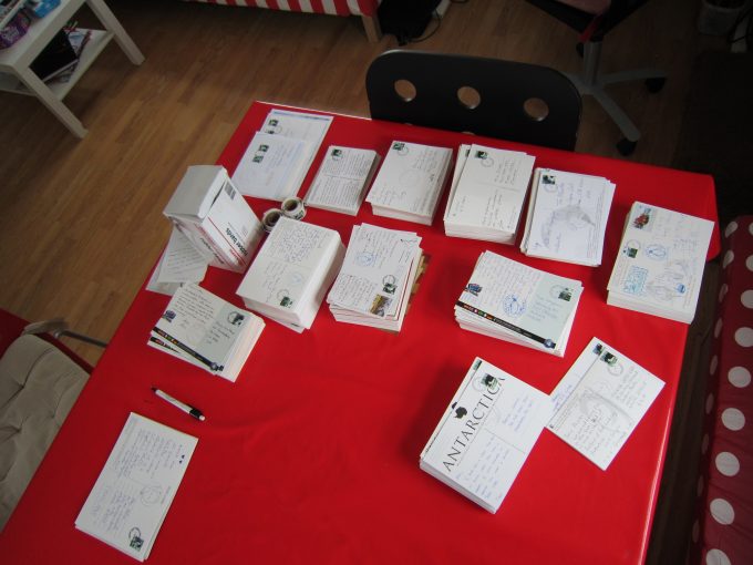 Hand franking thousands of postcard a day