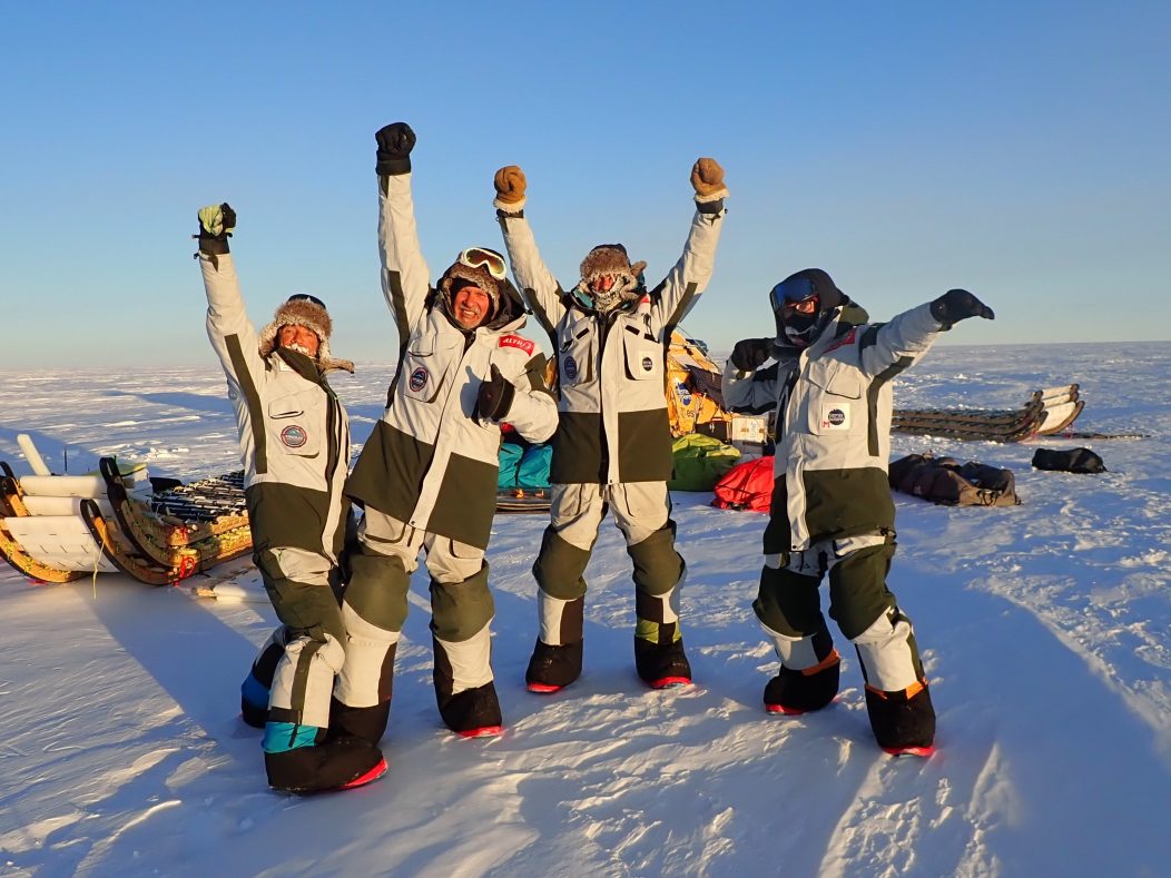 The WindSled team celebrate completing the 2,500 km expedition
